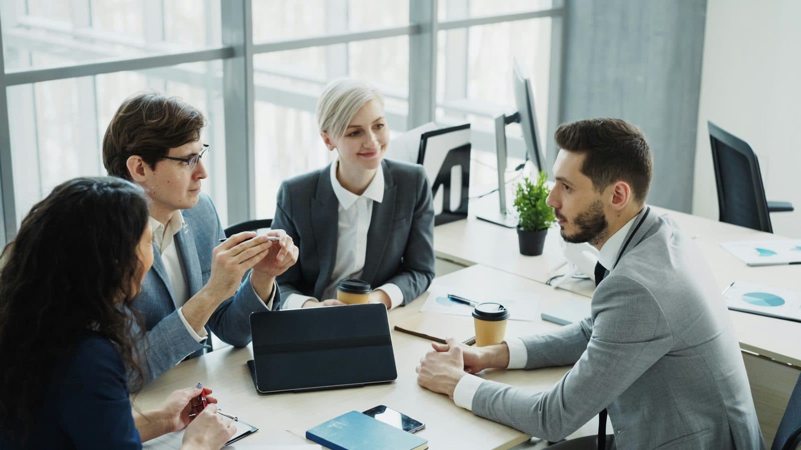 A team of professionals in a business meeting discussing a hiring decision